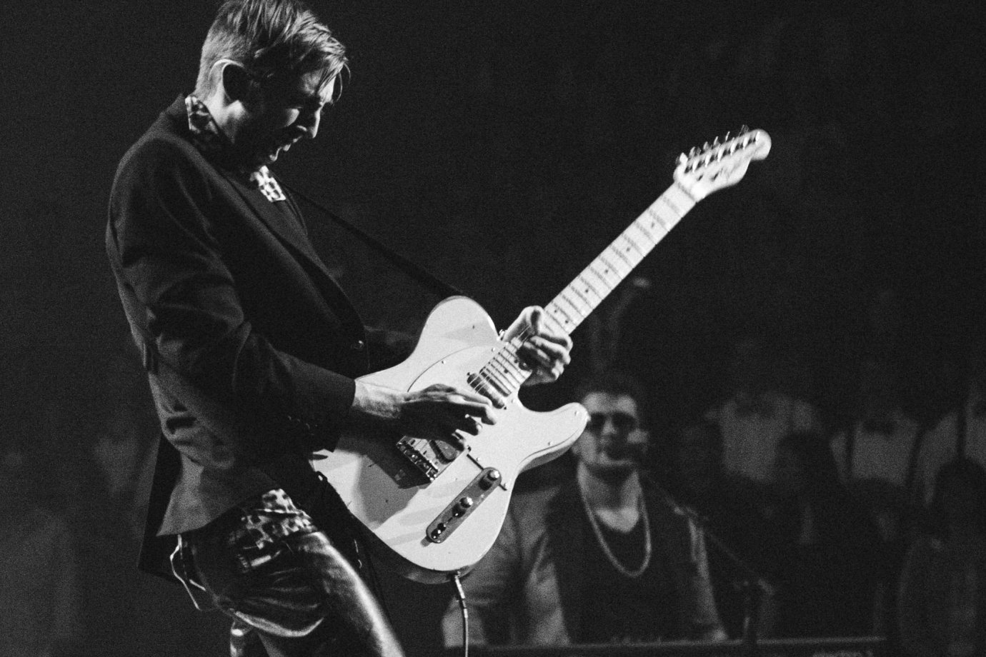 Photo by Andrew Spencer on Unsplash A solo guitarist playing in front of an audience.