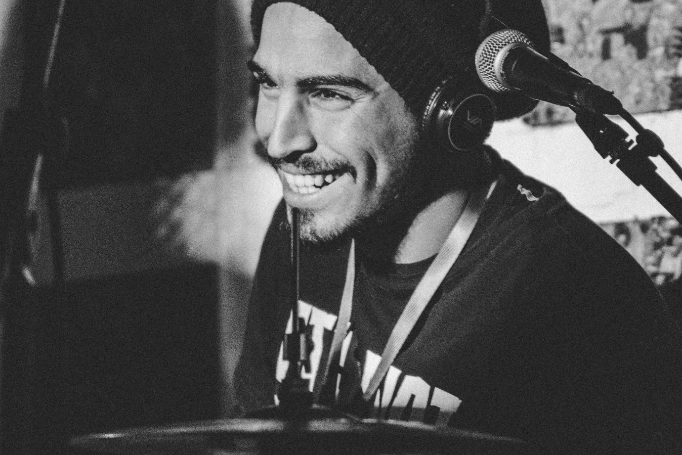 Photo by Latrach Med Jamil on Unsplash A black and white photo of a drummer smiling.